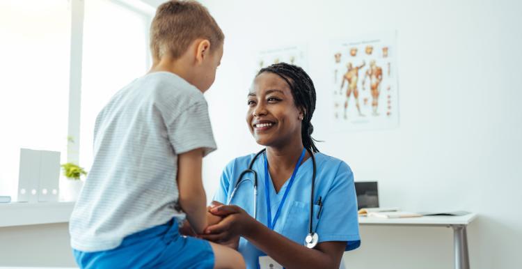 Photograph of a clinician with a young boy