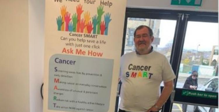 Volunteer Ric is seen at an event in Bradford where he is encouraging people to sign up as Digital Champions