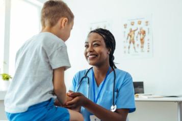 Photograph of a clinician with a young boy