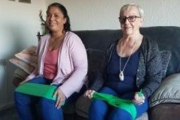Julie (left) and Susie (right) exercising with resistance bands