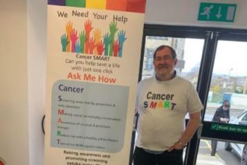 Volunteer Ric is seen at an event in Bradford where he is encouraging people to sign up as Digital Champions