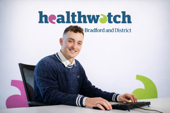 Image of Alkestid smiling whilst sat at a computer 